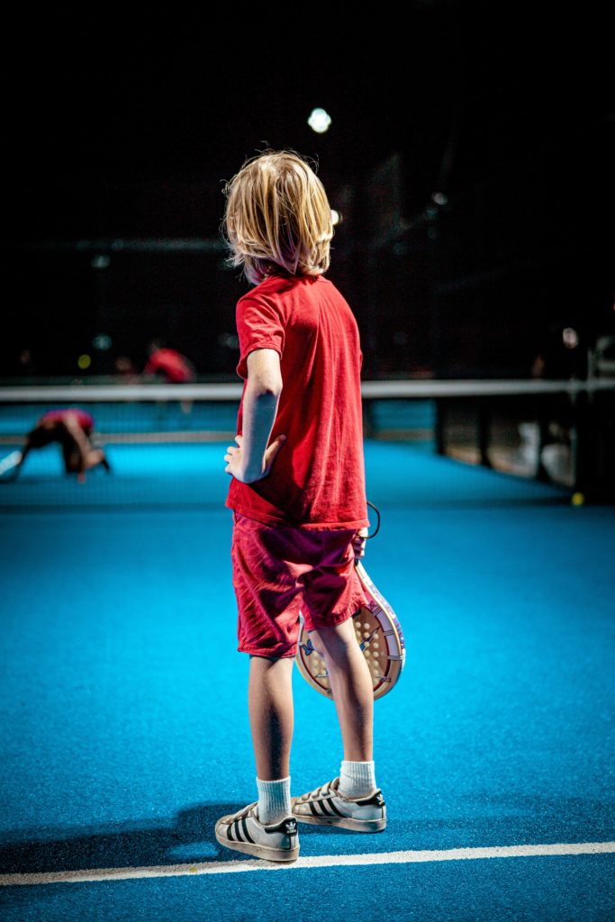 A Young Boy Playing Padel